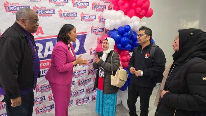 Latoya LeGrand speaks with supporters during the grand opening of her campaign headquarters in Jamaica, Queens, as residents and community leaders gathered to show support for her State Assembly campaign. 