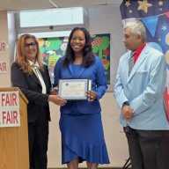 Community Board 9 Chairperson Sherry Algredo (left) presented Dr. Veronica Wiltshire (center) with an Award for her outstanding work in medicine and community service, as Dhanpaul Narine looks on, at a May 2 Honoring Hometown Heroes presentation by the Queens Book Fair.