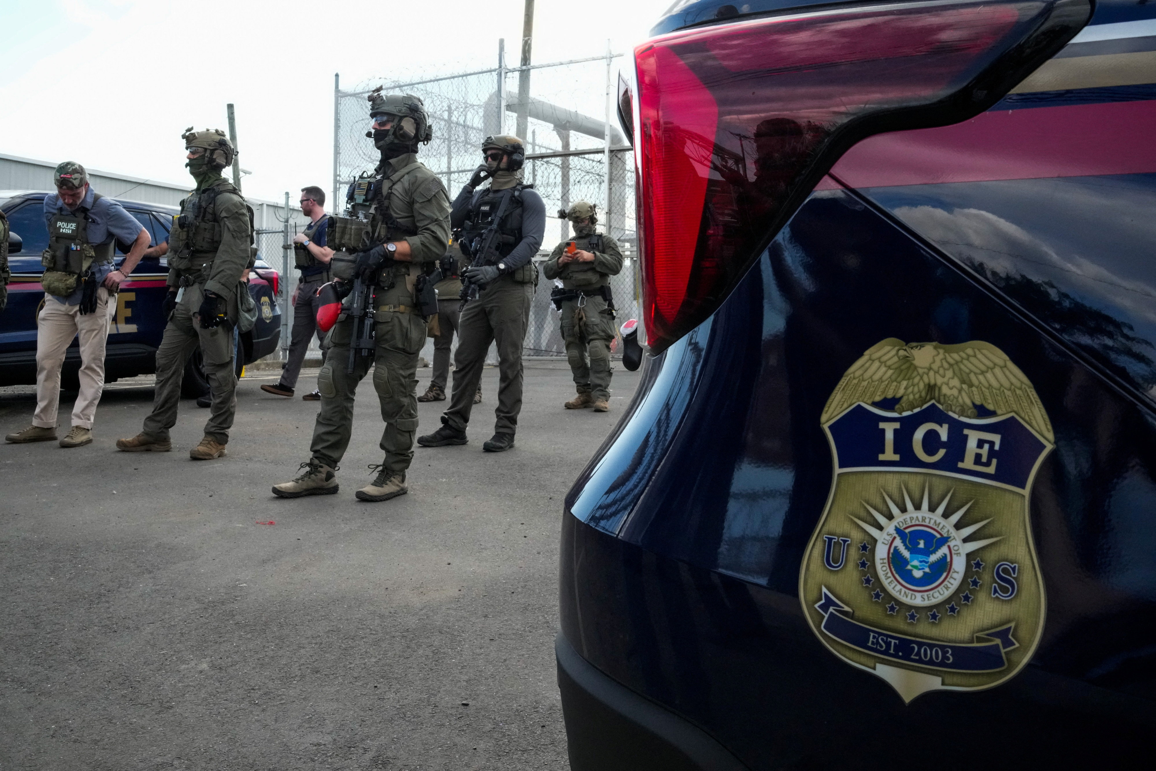 U.S. Immigration and Customs Enforcement (ICE) agents and federal agents secure the entrance to the Delaney Hall detention center, as demonstrators remain gathered outside, in Newark, New Jersey, U.S., May 29, 2026.