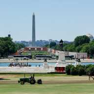 People maintain the grounds in front of the U.S. Capitol building, as construction is done on the National Mall for events related to the United States' 250th anniversary and the Washington Monument rises in the background, in Washington, D.C., U.S., June 3, 2026.