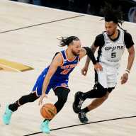 New York Knicks guard Jalen Brunson (11) dribbles against San Antonio Spurs guard Stephon Castle (5) in the second half during game five of the 2026 NBA Finals at Frost Bank Center.