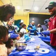 Families get a taste of Haiti as Jonathan Pierre Lafleur leads a hands-on pikliz workshop.