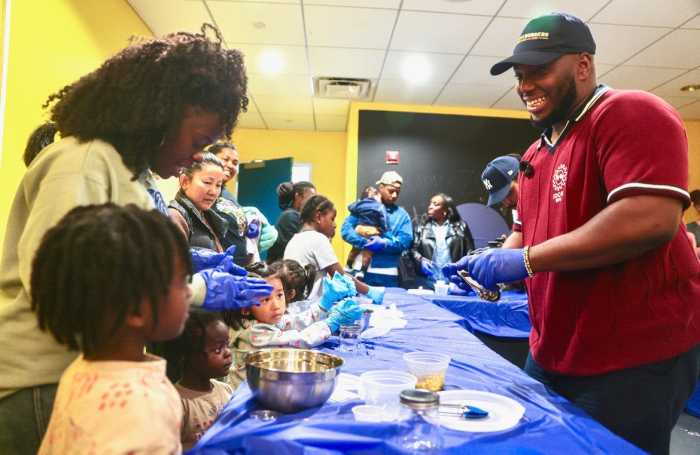 Families get a taste of Haiti as Jonathan Pierre Lafleur leads a hands-on pikliz workshop.
